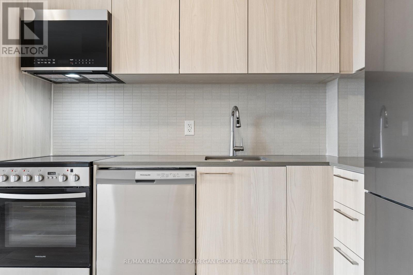 A kitchen with a black oven and a stainless steel dishwasher.