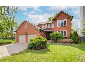A red brick house with a garage and a driveway.