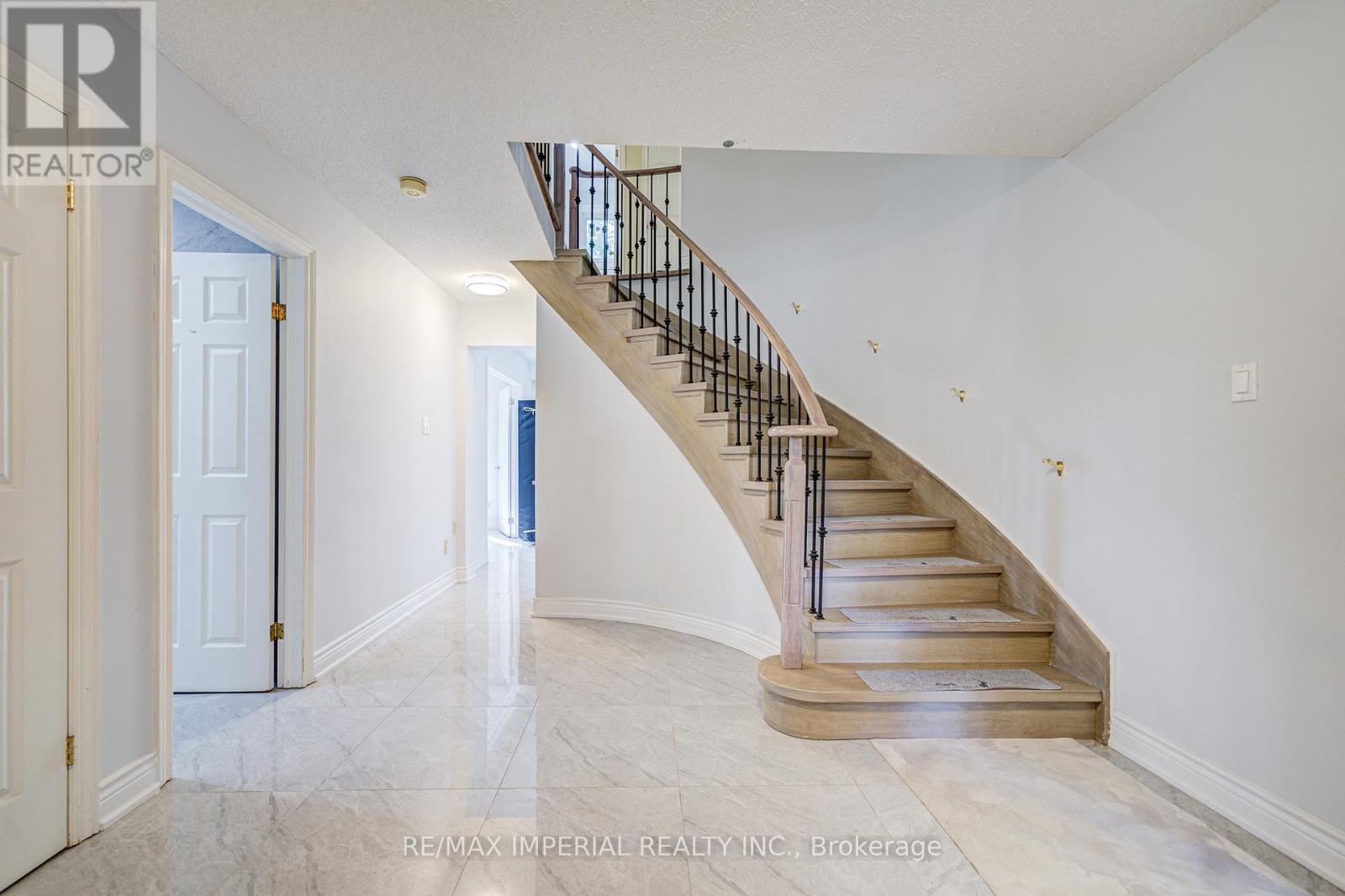 A spacious hallway with a staircase leading to the second floor.