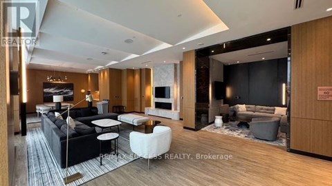 A modern living room with a black sofa and a white coffee table.