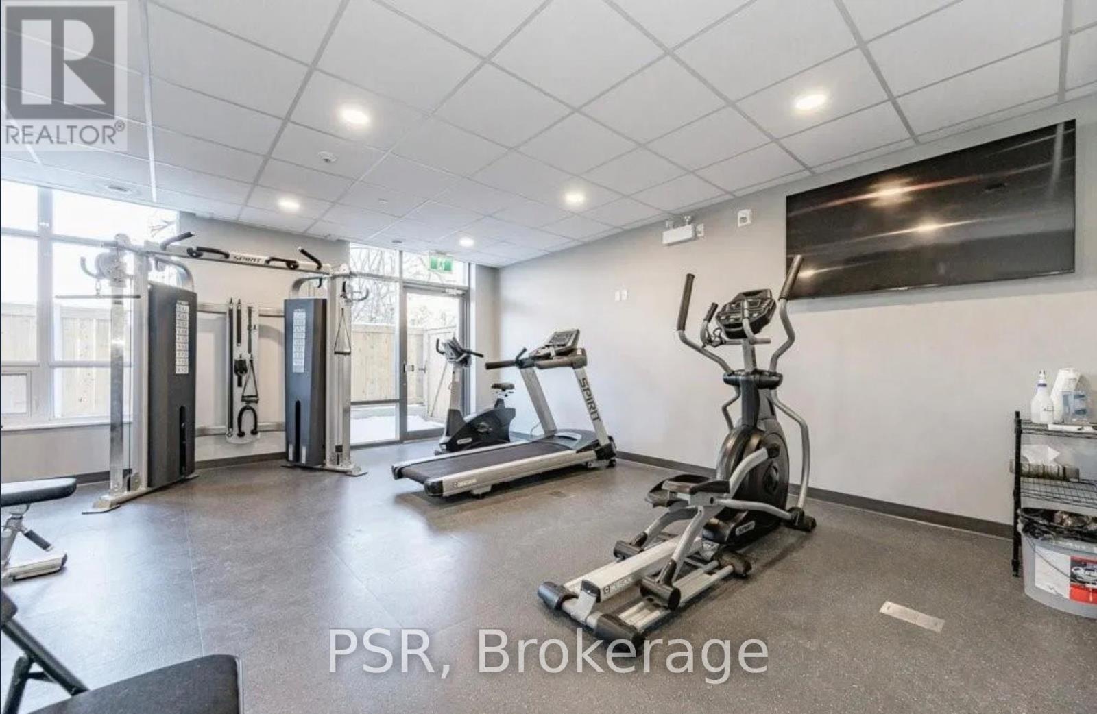 A gym with a variety of equipment including treadmills, weights, and exercise machines.