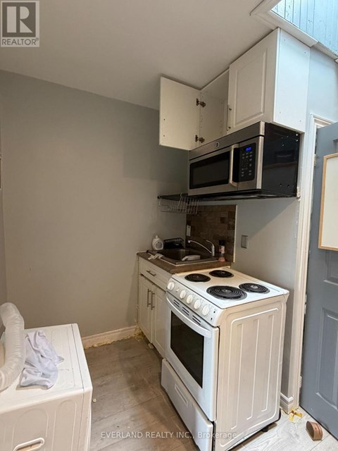 A white oven and microwave in a kitchen.