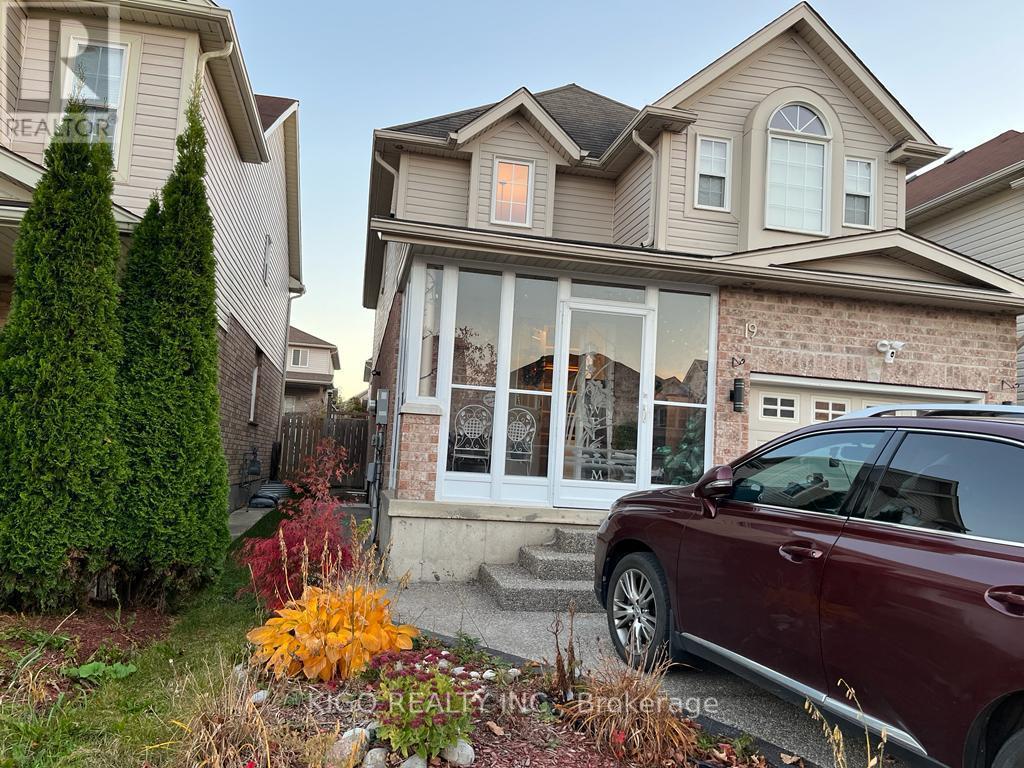 A house with a red car parked in front.
