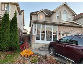 A house with a red car parked in front.