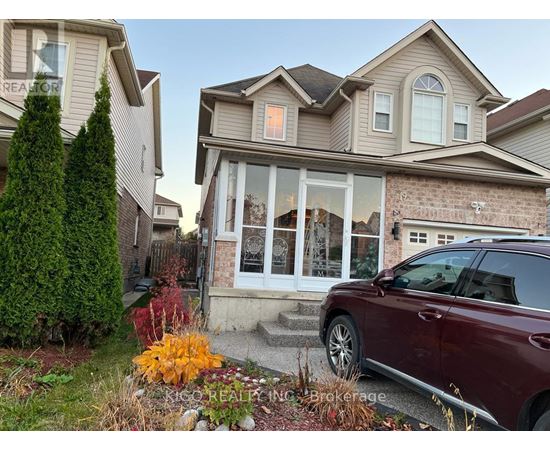 A house with a red car parked in front.