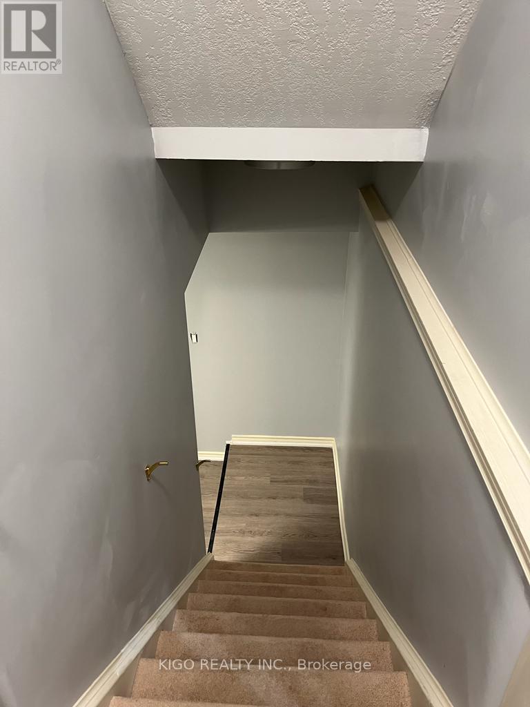 A stairway with a carpeted runner and wooden steps.