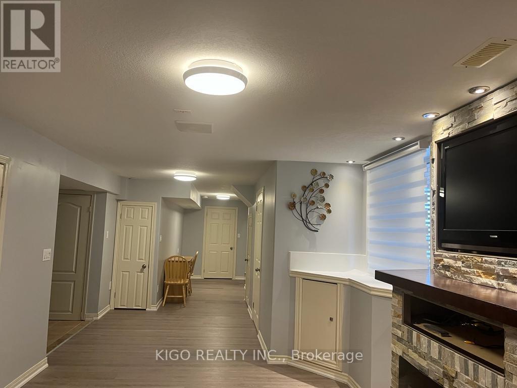 A living room with a flat screen TV mounted on the wall.