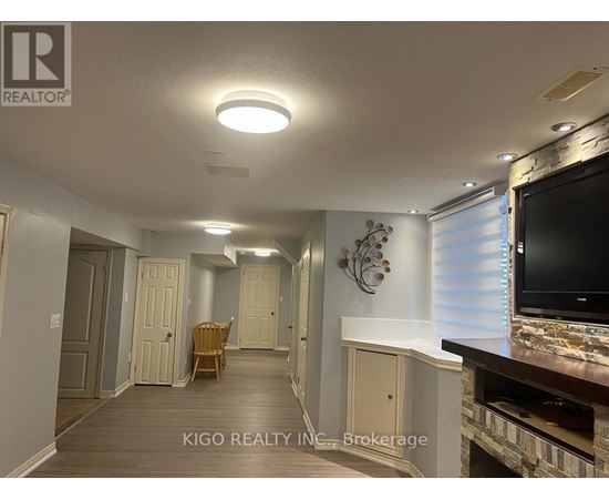 A living room with a flat screen TV mounted on the wall.