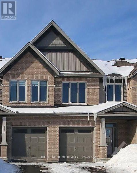 A house with a brown brick exterior and a grey roof.