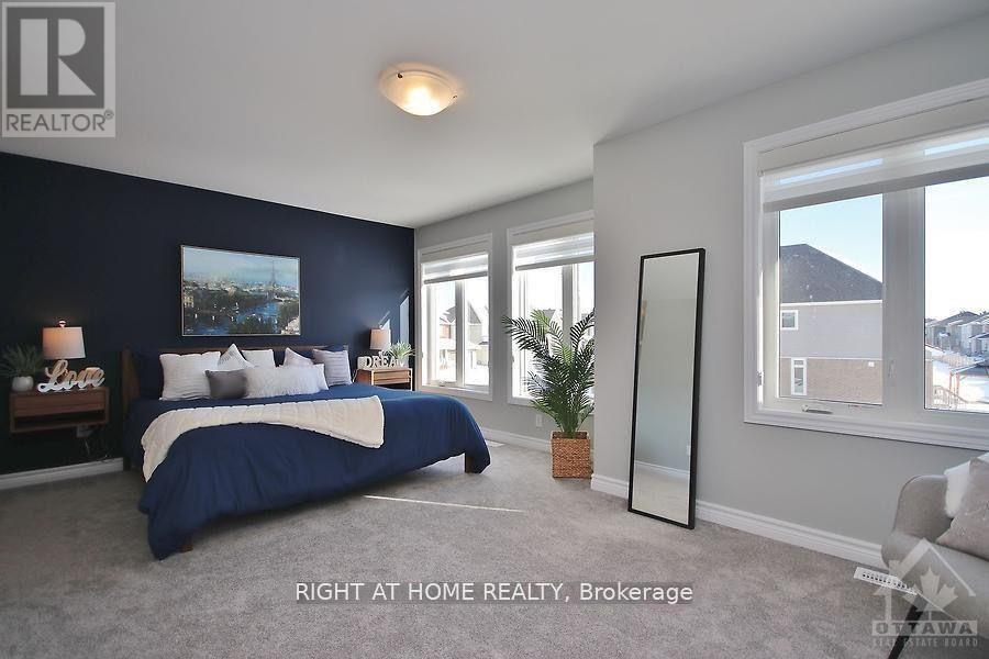 A bedroom with a large bed and a large window.