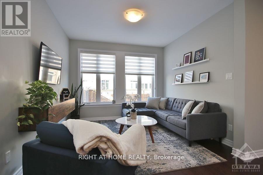A living room with a grey couch and a coffee table.