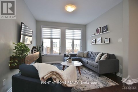 A living room with a grey couch and a coffee table.