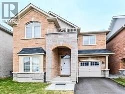 A two-story brick house with a garage.