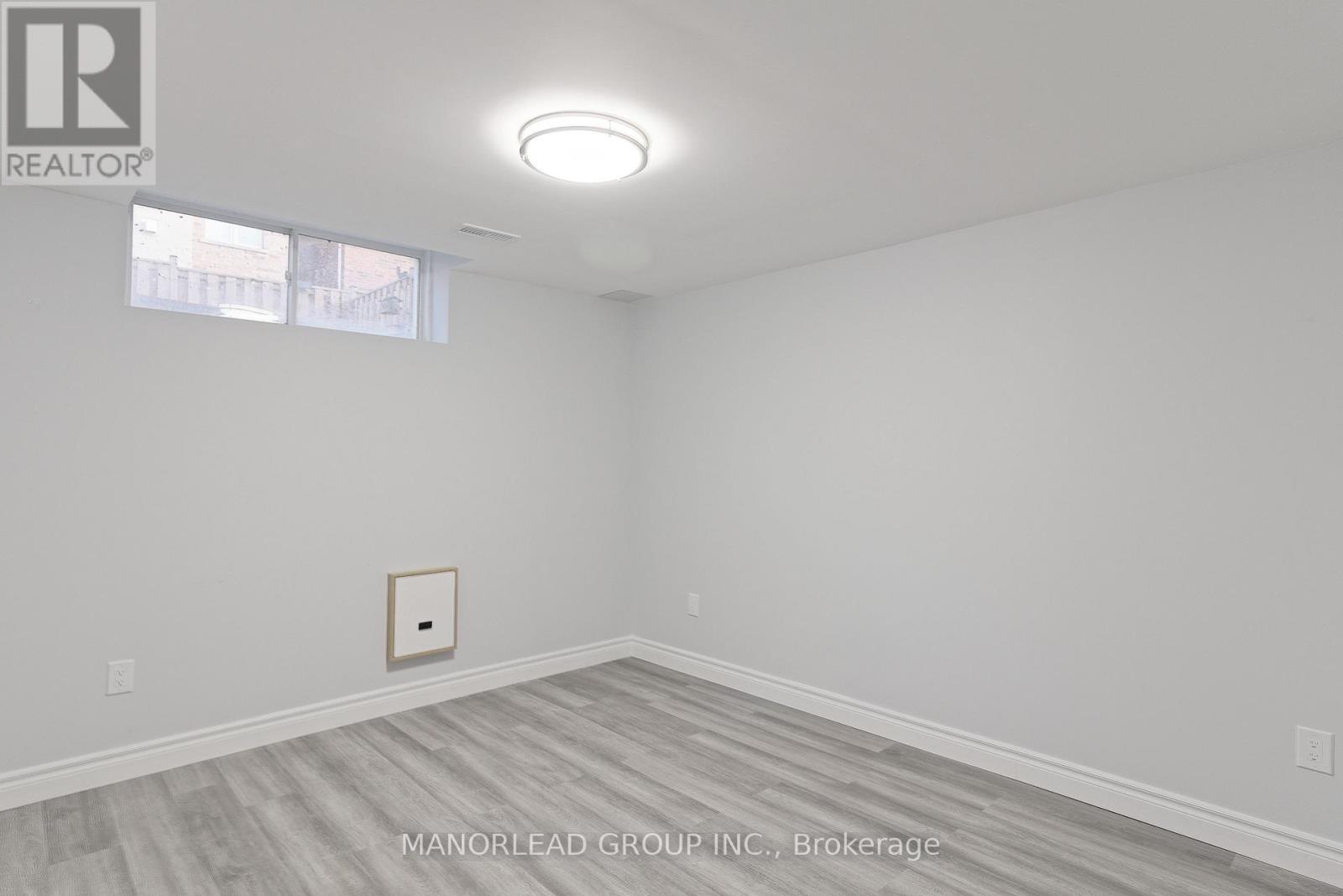 A room with a light on the ceiling and a picture on the wall.