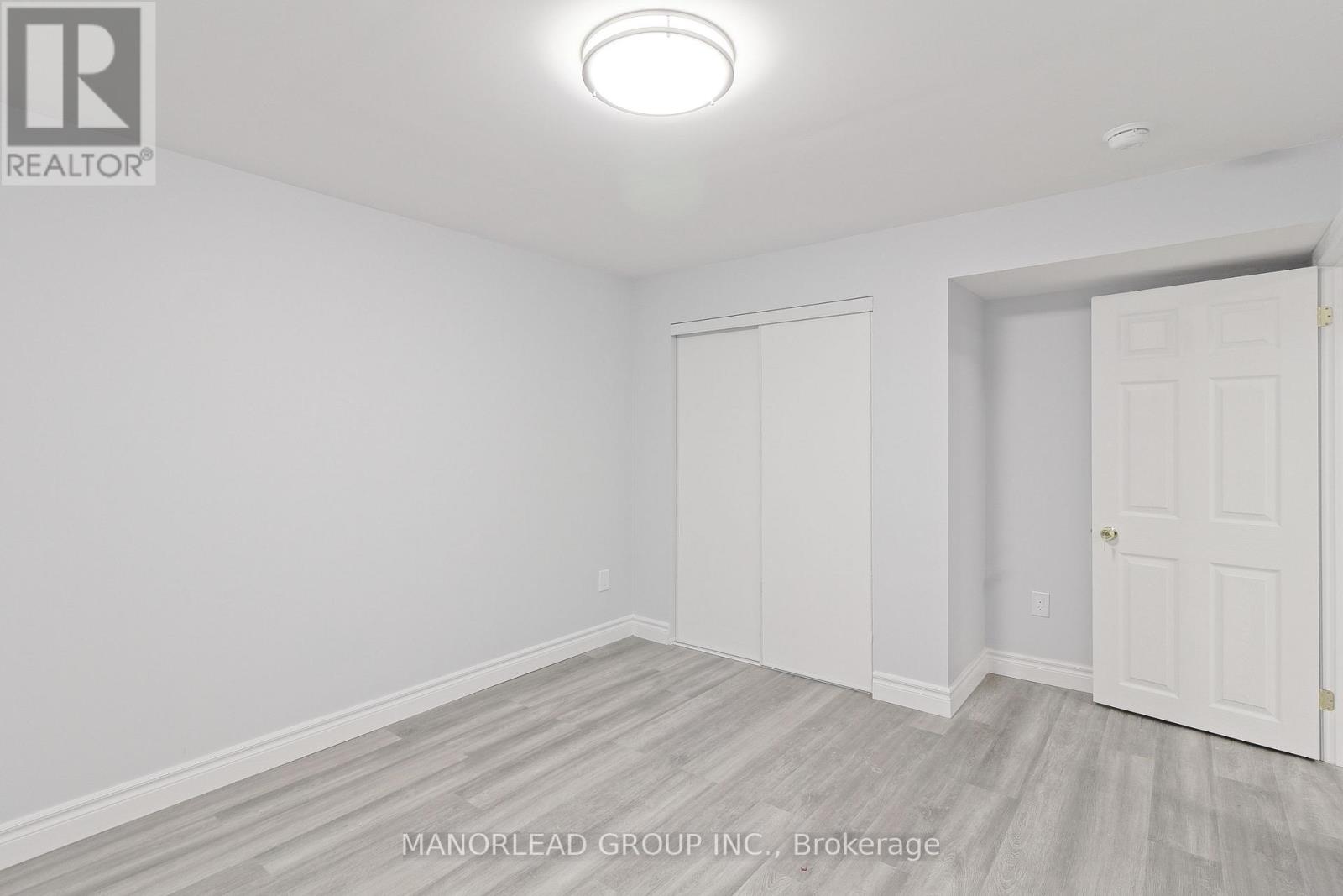 A room with white walls and a wooden floor.