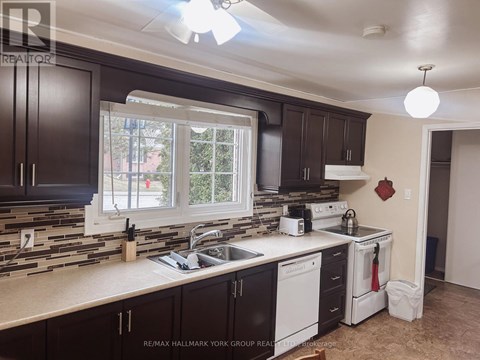 A kitchen with dark brown cabinets and a white counter top.