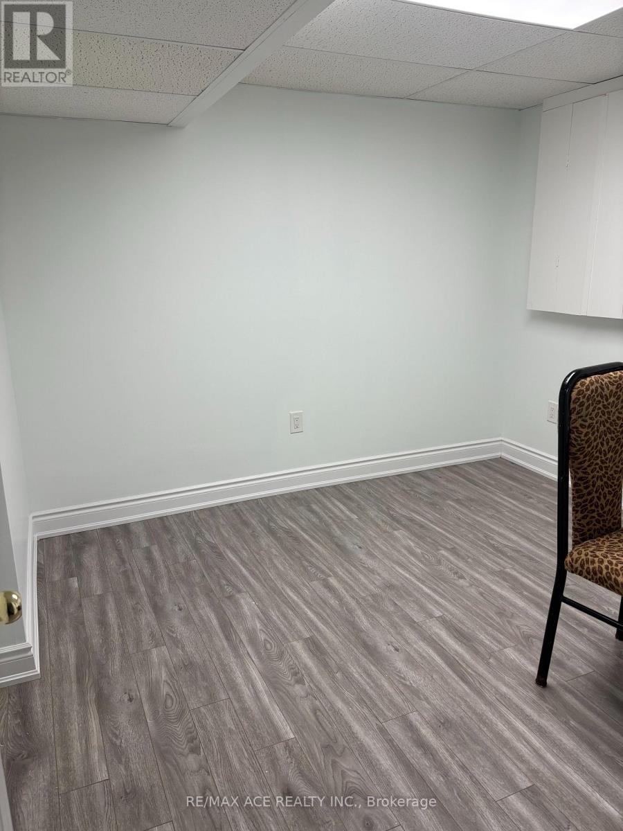 A room with a wooden floor and a chair.