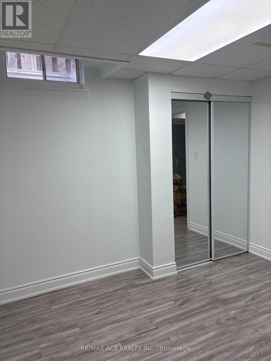 A brokerage office with a white wall and a wooden floor.