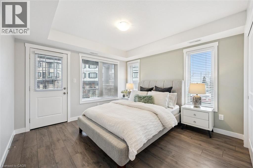 A bedroom with a large bed and a window with blinds.
