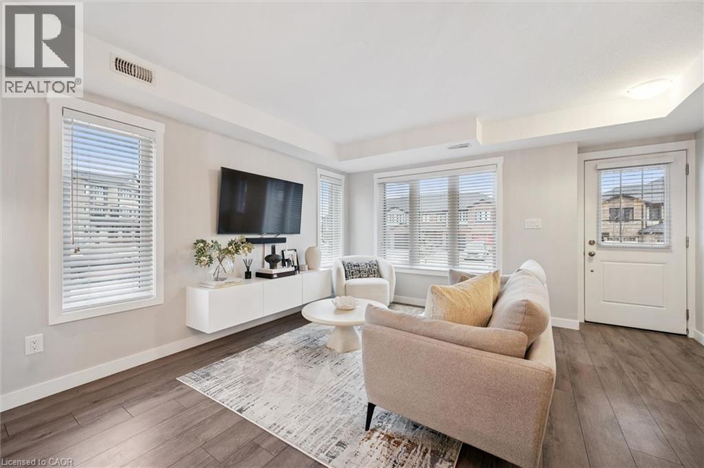 A living room with a couch, a television, and a rug.