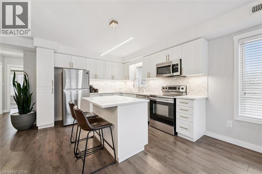 A modern kitchen with white cabinets and a center island.