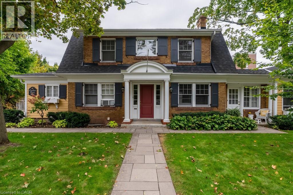 A house with a red door and a sign that says REALTOR.