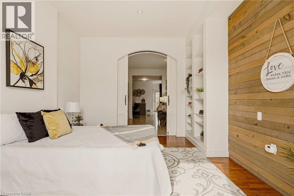 A bedroom with a large bed and a window.