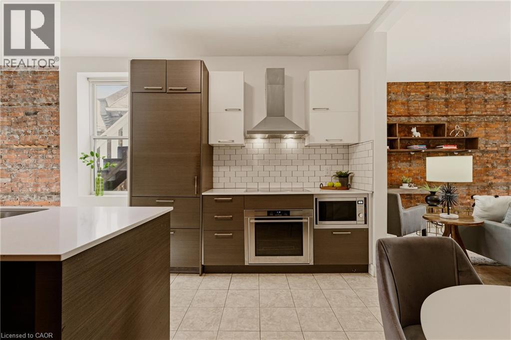 A modern kitchen with a dining table and chairs.