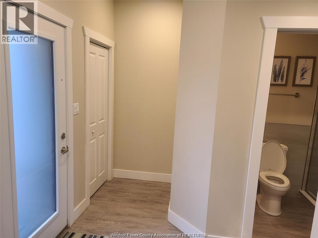 A bathroom with a toilet and a door.