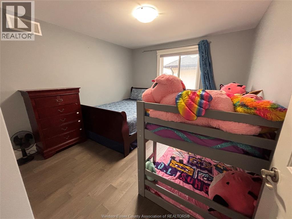 A bedroom with a bunk bed and a dresser.
