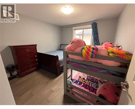 A bedroom with a bunk bed and a dresser.