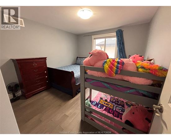 A bedroom with a bunk bed and a dresser.