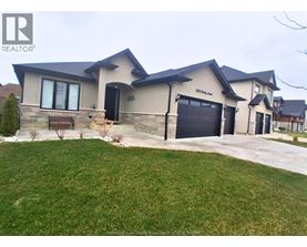 A house with a large front yard and a garage door.