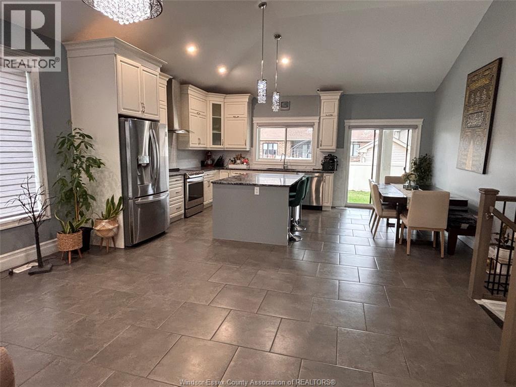 A spacious kitchen with tile flooring and a dining area.