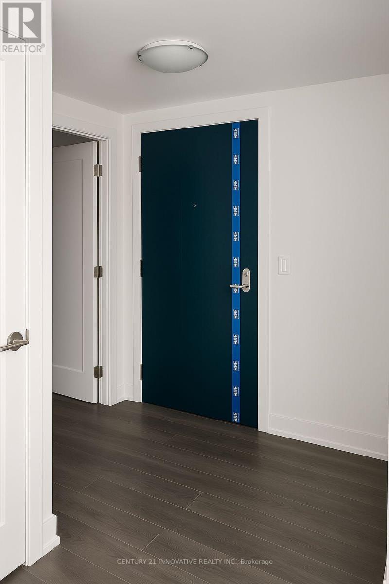 A dark blue door is in a white hallway.