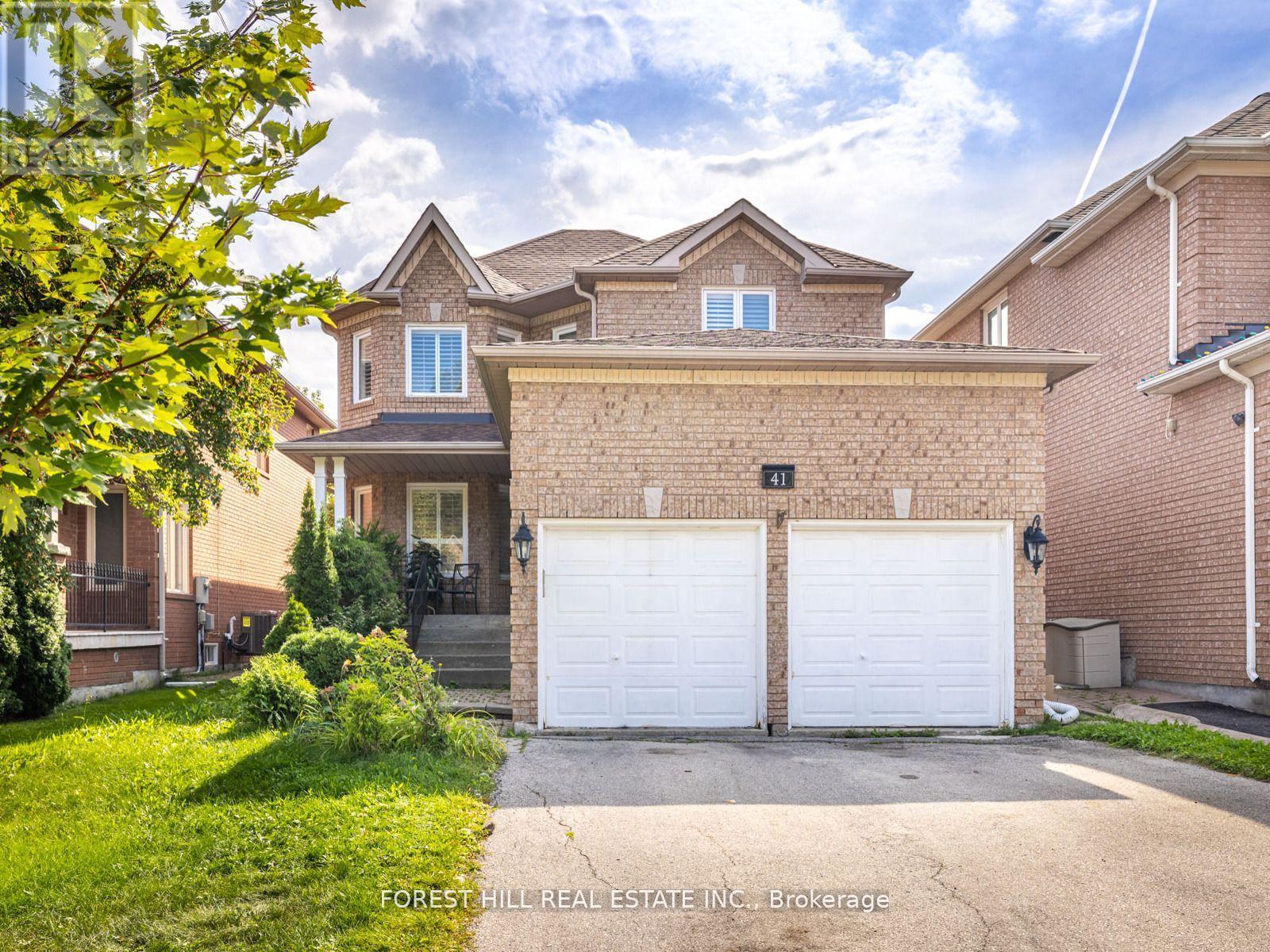A house with a white garage door is for sale by Forest Hill Real Estate Inc.