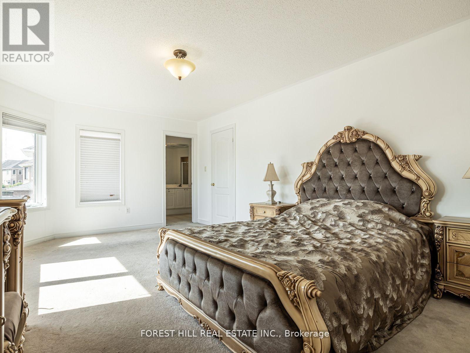 A bedroom with a large bed and a dresser.