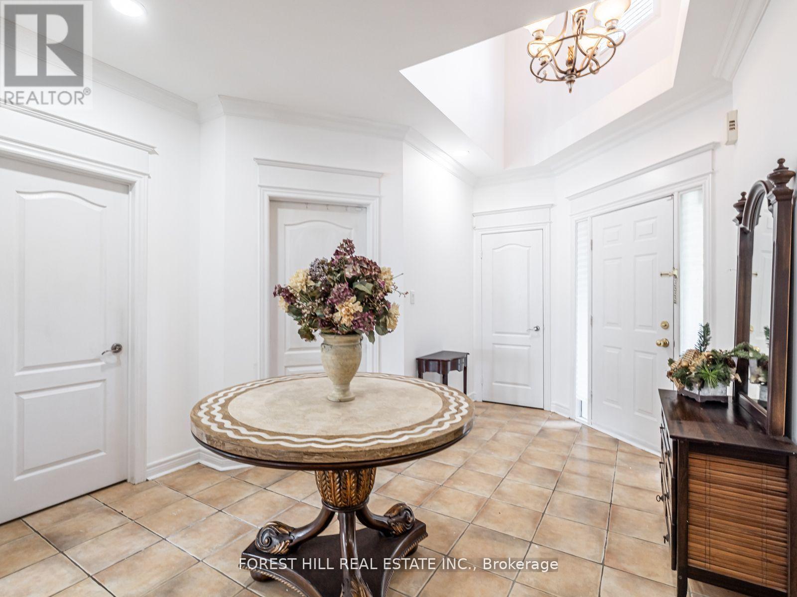 A dining room with a table and chairs.