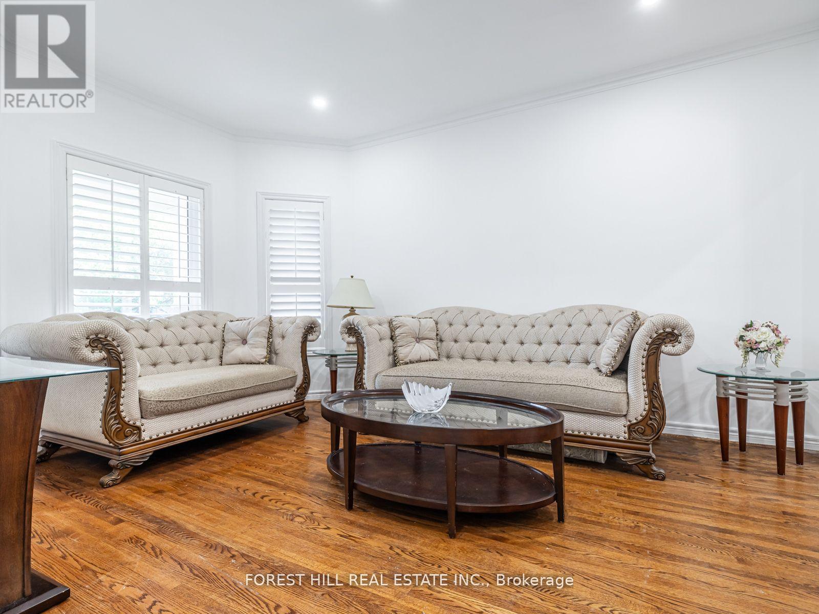 A living room with a white sofa and a wooden coffee table.
