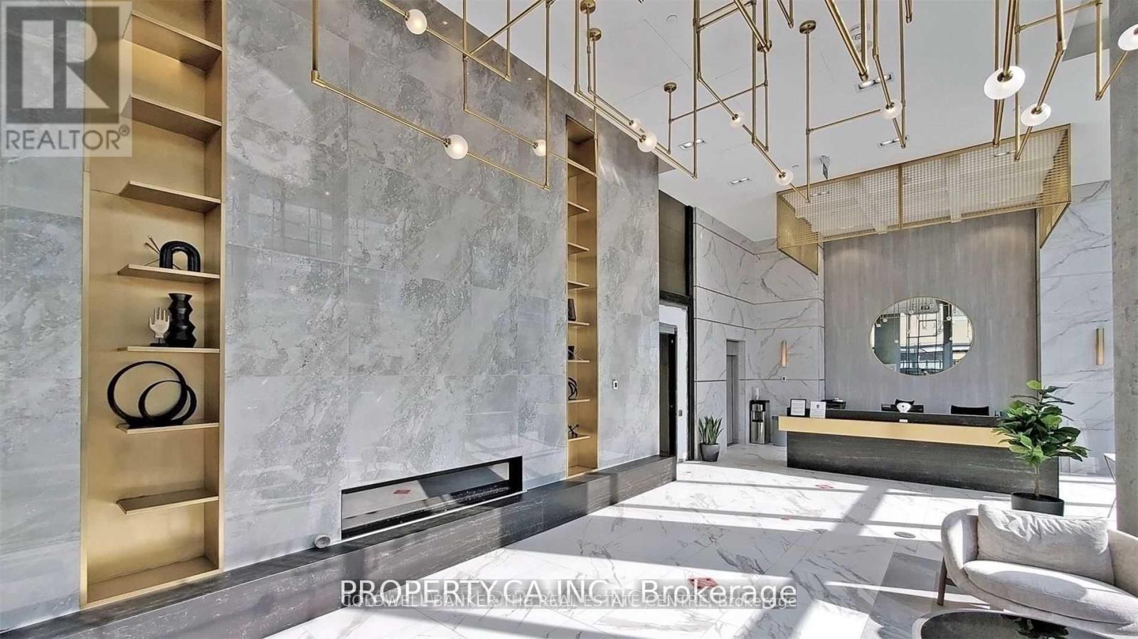 A modern living room with a marble wall and a large mirror.