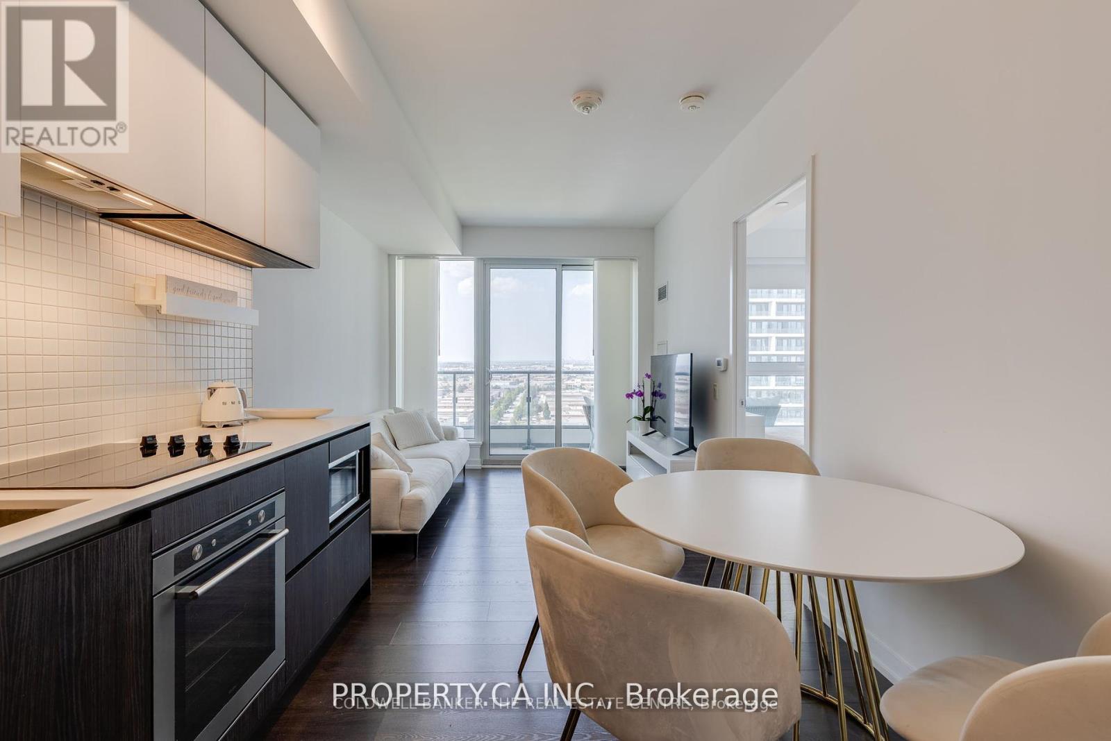 A modern kitchen with a dining table and chairs.