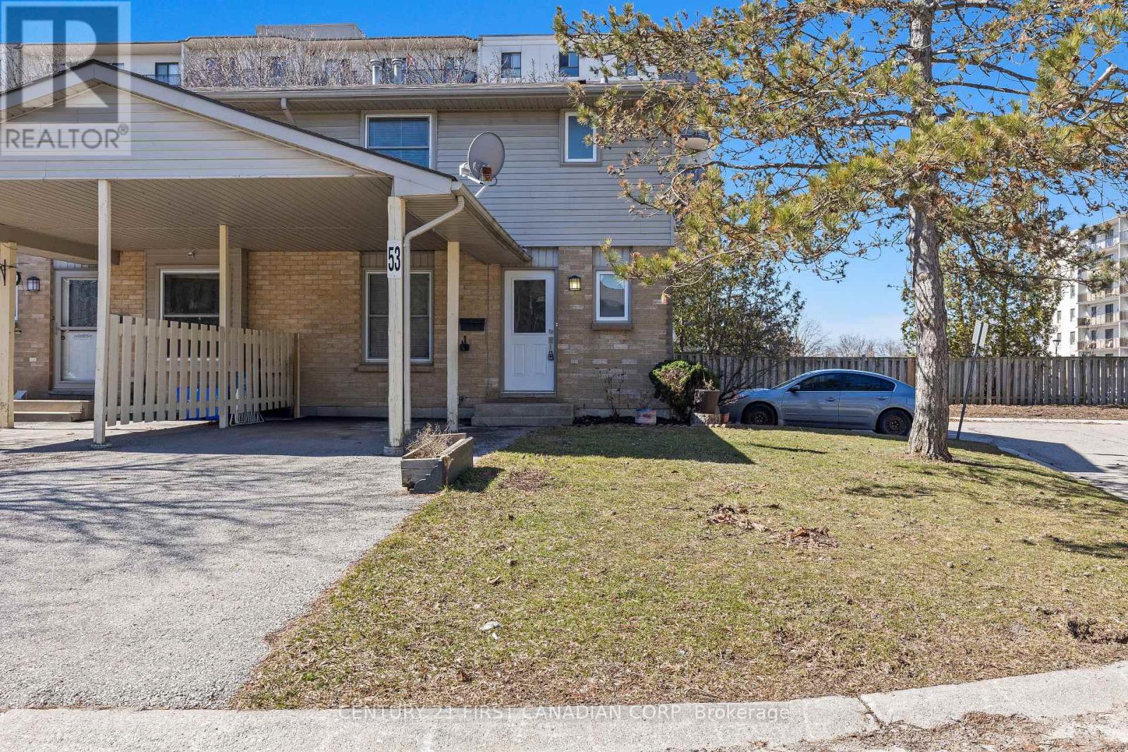 A house with a car parked in front of it.