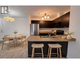 A modern kitchen with a bar stool and a dining table.