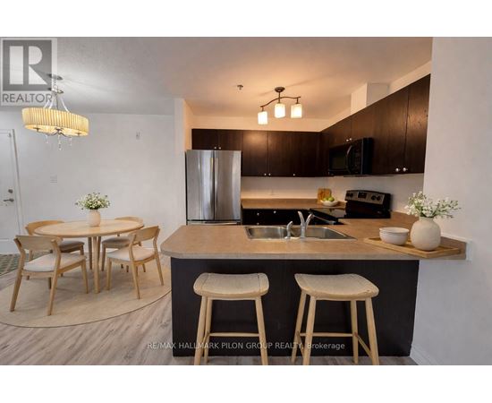 A modern kitchen with a bar stool and a dining table.