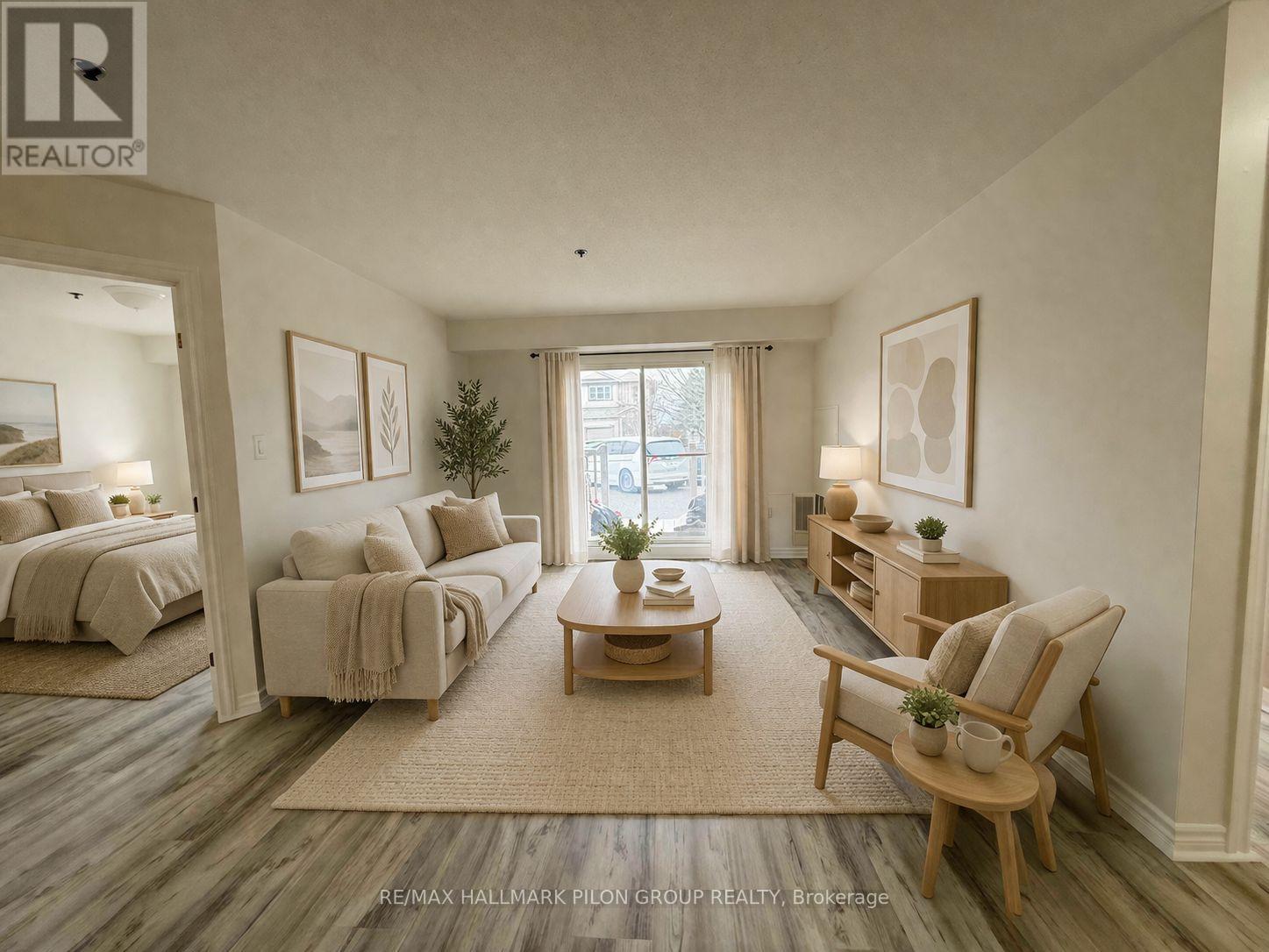 A well-lit, spacious bedroom with a large bed and a comfortable seating area.