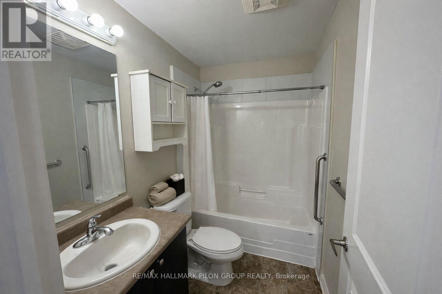 A white bathroom with a sink, toilet, and bathtub.