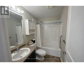A white bathroom with a sink, toilet, and bathtub.