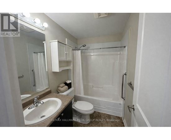 A white bathroom with a sink, toilet, and bathtub.