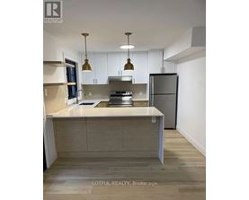 A modern kitchen with a large island and stainless steel appliances.