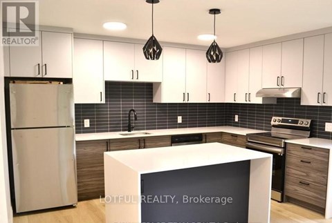 A modern kitchen with a white refrigerator and black and white decor.